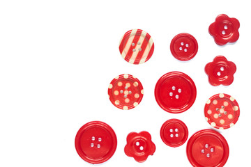 Various red sewing buttons isolated on background