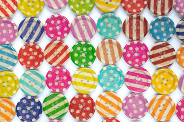 Full frame photo of various colorful sewing buttons on white background