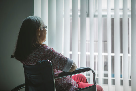 Disabled Old Woman Looking Out The Window