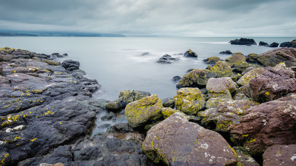 Fototapeta na wymiar On Skernaghan Point’s rocky shoreline, Browns Bay, Islandmagee, County Antrim, Northern Ireland.