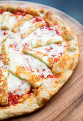 Delicious, fresh and tasty flat bread italian pepperoni or margherita pizza. View of cheese and basil pizza in restaurant at napoli. Pizza background texture pattern