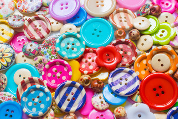 Full frame and selective focus photo of various and colorful sewing buttons