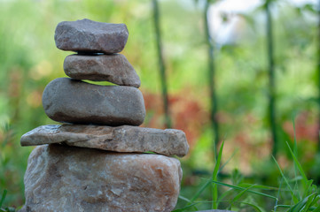 Fototapeta na wymiar pyramid of stones on a green background
