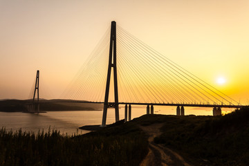 Cable-stayed bridge "Russky Bridge" to island Russkiy on the sunset. Vladivostok, Primorsky Krai, Russia