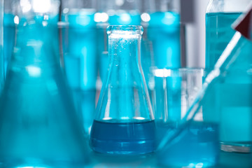 Researchers are using glassware and blue solutions in laboratories, research on cosmetics and energy.