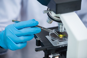 Close-up shot of microscope with metal lens at laboratory.