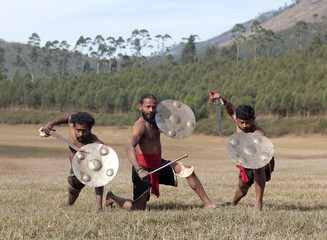 Indian fighters with sword and shield - Kalaripayattu marital art demonstration in Kerala, India