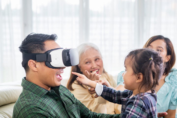 Happy man wears a VR headset with his family