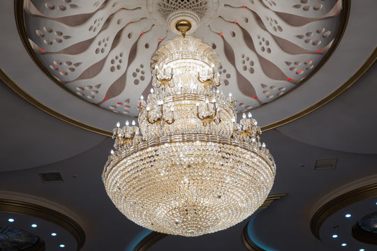 illustration of a chandelier with crystal pendants on the black . Palace ball hall for dancing, ballroom. Big and old expensive crystal chandelier .