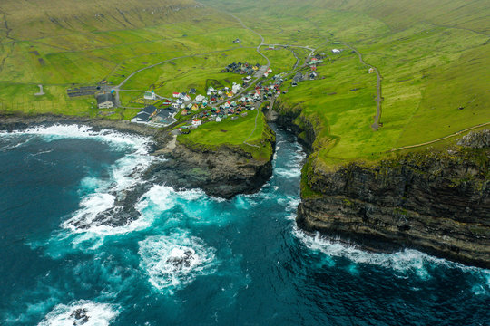 Natural harbour gorge in Gjogv village aerial view, Faroe Islands
