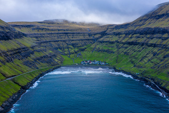 Tjornuvik village and beach and waterfalls aerial view, Faroe Islands