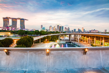 Fototapeta na wymiar SINGAPORE, SINGAPORE - MARCH 2019: Vibrant Singapore skyline with Marina Bay Sands, Gardens by the bay with cloud forest, flower dome and supertrees at sunset. Top view from marina barrage