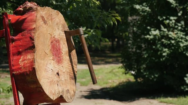 cossack throwing old retro axe in the wooden target outdoors on the summer festival