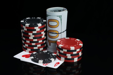 poker player kit: winning cards, stack of chips and a  100-dollar bills