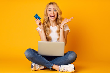 Surprised Woman Sitting With Laptop And Credit Card