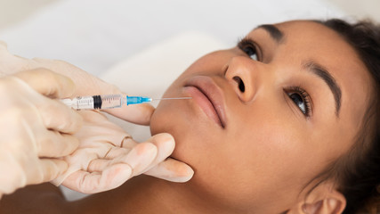 Lip Augmentation. Afro Woman Receiving Hyaluronic Acid Injection