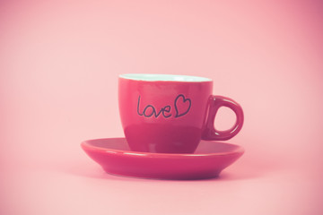 red coffee cup on pink background