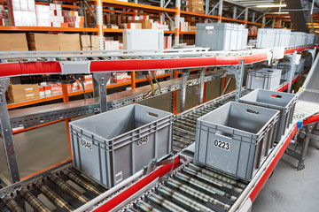 Automated warehouse. Boxes with spare parts moving on conveyer