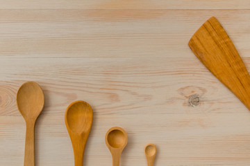 Empty wooden spoons on wooden background, copy space