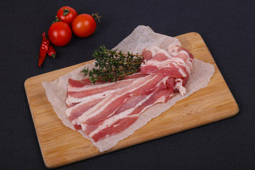 Raw bacon on the board