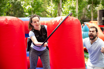 Woman putting hoop on inflatable pole