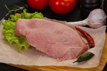 Raw Turkey steak served rosemary