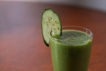 A glass of green fruit and vegetable smoothies