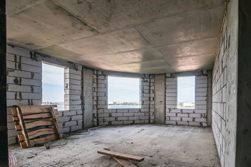 Unfinished room interior inside in construction site of new modern residential building