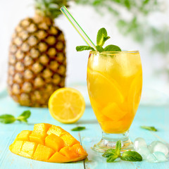 Yellow iced tea with pineapple, lemon