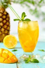 Yellow iced tea with pineapple, lemon