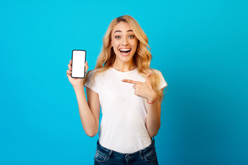 New App. Happy Girl Showing Blank Smartphone Screen
