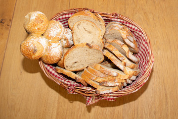 sliced bread assortment in a basket on wood table