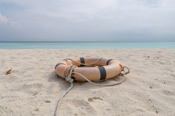 Lifebuoy and rope lie on the beach of a tropical beach.