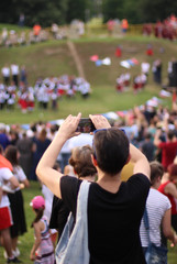 Woman taking photo of live stage performance