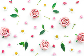 Pink rose flowers and green leaves on white background, flat lay, top view