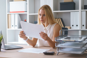 young beautiful woman work at office with documents sit at table study information