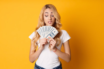 Doubtful Girl Holding Bunch Of Money Banknotes