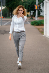 young beautiful woman walk on street spend time on fresh air