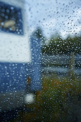 spellbinding landscape of Norwegian nature with high charming mountains and hills, wonderful rivers imprinted on photos of traveler throw window with rain drops