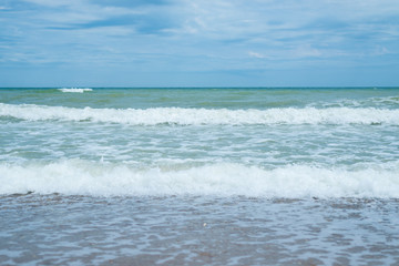 Fototapeta na wymiar Sea surf on the beach. Waves coming ashore.