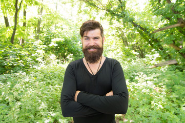 Naklejka na ściany i meble Handsome man with beard and mustache summer vacation. Brutality of jungles concept. Summer heat season concept. Wild nature. Man bearded hipster bright foliage background. Guy relax in summer forest