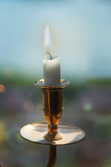 Vintage brass candlestick on blurred background