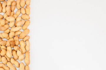 Large peeled peanuts close-up of beans in the shell. Unpeeled peanuts in the shell. Peanuts, for...