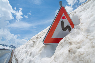 Signpost almost buried in the snow, Italian Alps, altitude 2200 meters over sea level