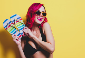 Young pink hair girl in bikini and orange glasses