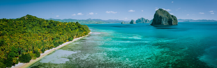 Panoramic drone aerial view of coastal scenery from the mainland Palawan with tropical Pinagbuyutan islands on horizon. El Nido-Philippines. Best natural wonder in Southeast Asia Bacuit archipelago