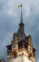 Clock Tower with Romanian flag in Peles Castle, Carpathian Mountains, Romania