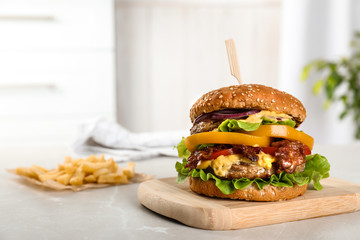 Board with tasty burger on table. Space for text - obrazy, fototapety, plakaty