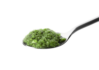 Spoon of tasty pesto sauce isolated on white