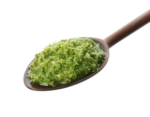 Spoon of tasty pesto sauce isolated on white